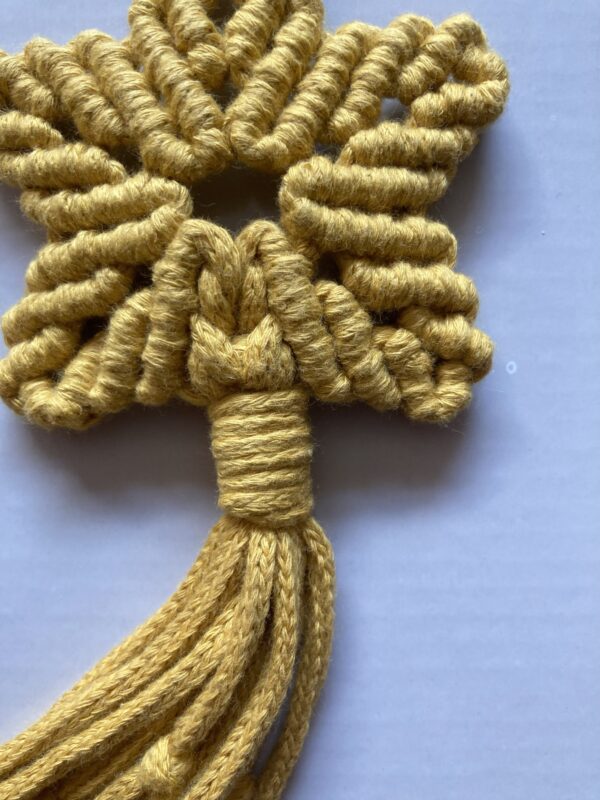 A handmade macrame star in mustard yellow cotton braided cord. - Image 3