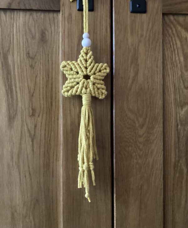 A handmade macrame star in mustard yellow cotton braided cord. - Image 5