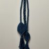 handmade macramé wall hanging/decoration made from a chunky yarn in vibrant teal blue.