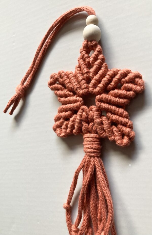 A handmade terracotta orange macrame star. - Image 2