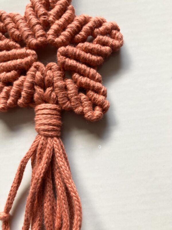 A handmade terracotta orange macrame star. - Image 3