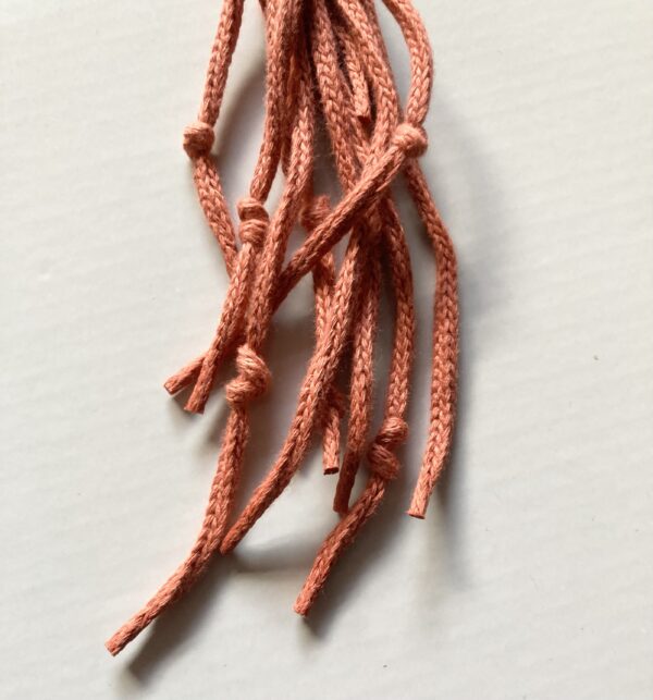 A handmade terracotta orange macrame star. - Image 4